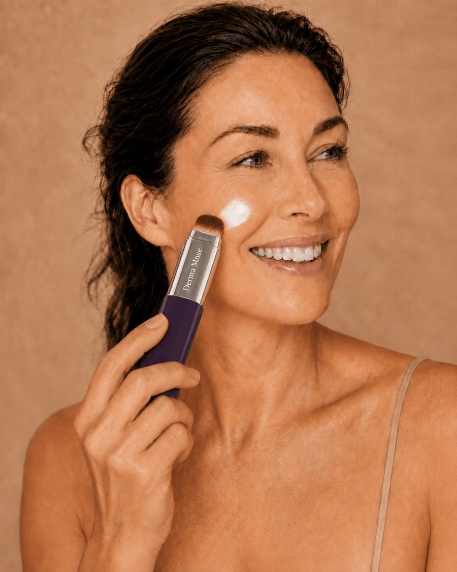 Blending the white balm across the cheek with the built-in brush